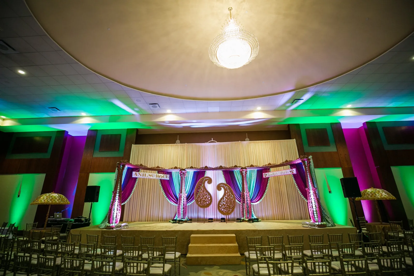 Jewel-tone sangeet stage decor by Poonam Creations